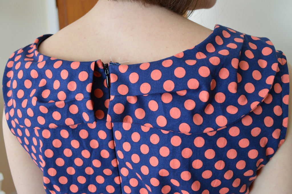 Back of Licorice Dress in coral and navy dots
